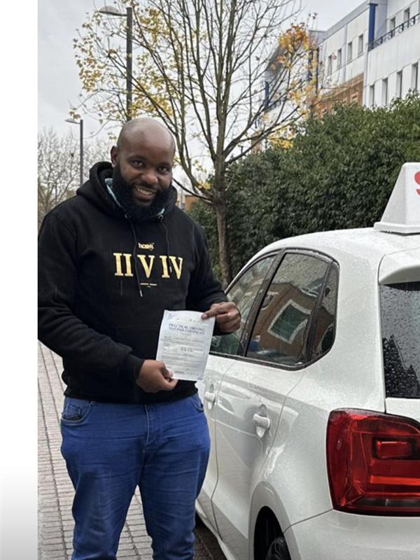 Pupil with pass certificate beside the lesson car