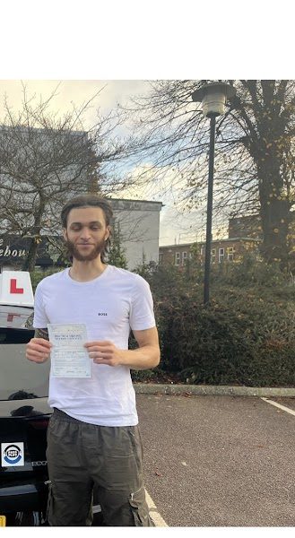 Learner holding a DVSA driving test pass certificate after automatic lessons in Tottenham